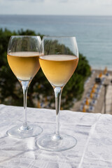 Celebration, birthday party, pouring of sweet muscat white wine from Pantelleria island on holiday on Mondello beach, Palermo, Sicily, Italy