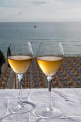 Celebration, birthday party, pouring of sweet muscat white wine from Pantelleria island on holiday on Mondello beach, Palermo, Sicily, Italy