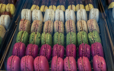 Macarons or French macaroon sweet meringue-based confection made with egg white, icing sugar, granulated sugar, almond meal, and food colouring, sweet french dessert on display
