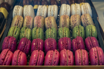 Macarons or French macaroon sweet meringue-based confection made with egg white, icing sugar, granulated sugar, almond meal, and food colouring, sweet french dessert on display