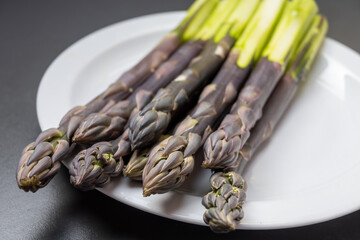 Garden or farm to table concept, fresh organic purple asparagus vegetables, seasonal foood, tasty healthy food