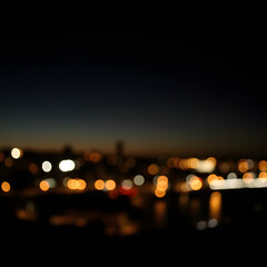 Blurred city lights at night, bokeh effect background.