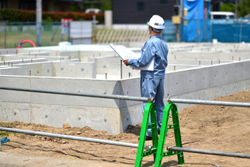 住宅建築の基礎を点検する工事監督