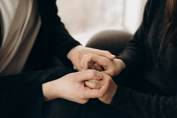Couple hold each other hands.