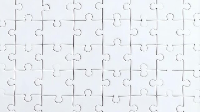 Close-up overhead view of a completed plain white jigsaw puzzle showing a sense of unity and problem solving using strategy