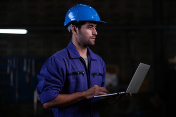 Fototapeta premium Portrait of foreman, engineer or architect with safety helmet holding laptop and blueprints for inspection details on factory industry material.
