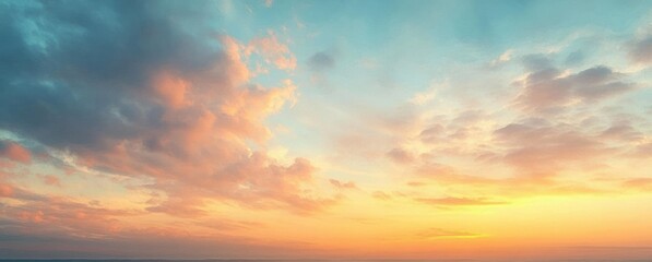 Fototapeta premium Beautiful expansive sky at sunset with soft colorful clouds and warm golden light creating a peaceful and serene atmosphere