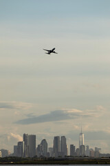 Airplane taking off above the New York City skyline