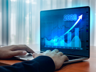 Arrow up from 2025 to 2026 year calendar numbers on digital growth graph chart on laptop computer...