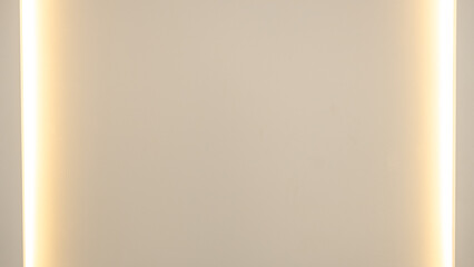 Symmetrical wall background with vertical ambient lighting on both edges. Soft golden tones create a clean, minimalist design perfect for templates, interiors, or product mockups.