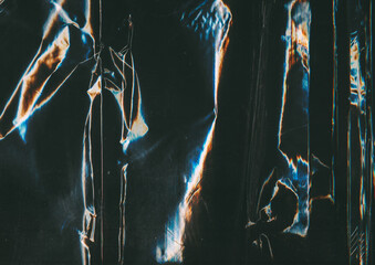 Creased texture. Metallic abstract background. Blue orange color film dust scratch glitch defect...