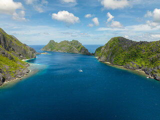 Boat running over the blue sea with waves. Tapiutan and Matinloc. El Nido, Palawan. Philippines.