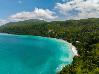 Transparent turquoise water and white beach with sunlight reflection. Samal Island. Davao, Philippines.