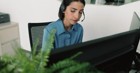 Serious thoughtful young Latin client support office employee in headset working at laptop, touching chin, thinking on task, looking at monitor, typing, getting thoughtful, pensive - Powered by Adobe