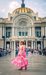 Tourist woman in yellow dress at Torre Latinoamericana in Mexico City