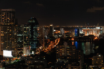 Bangkok City Skyline at Night with Reflections and Illuminated Streets