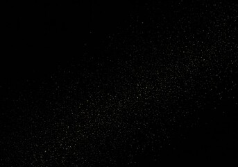 Fototapeta premium Golden glitter scattered on a dark black background for festive effect