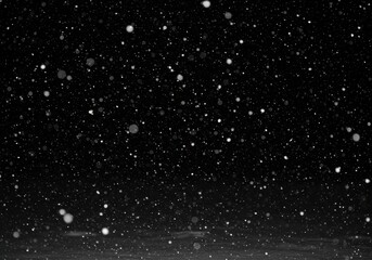 Obraz premium Dense snowfall against a dark black background creating a winter scene