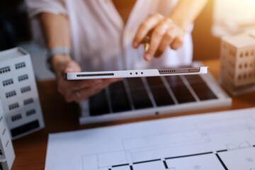 Discussion among businesspeople on the latest developments in solar cell panel technology and Solar Energy Environment city Concept.