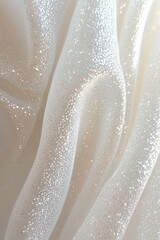 Close-up of soft white fabric with delicate glittery sequins creating shimmering waves and folds