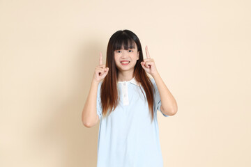 20s Asian Woman in Light Blue Shirt and White Shorts