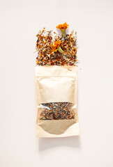 Marigold Seeds and Dried Petals Spilling from a Craft Paper Pouch. Herbal Tea with Natural Ingredients.