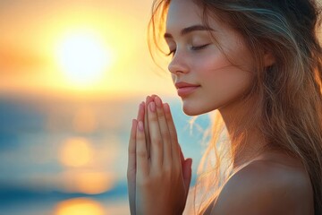 Young woman with closed eyes and hands held together in prayer or meditation by the sea at sunset, peaceful and serene expression