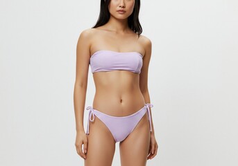 Naklejka premium Woman in swimwear posing for a summer fashion shoot against a white background