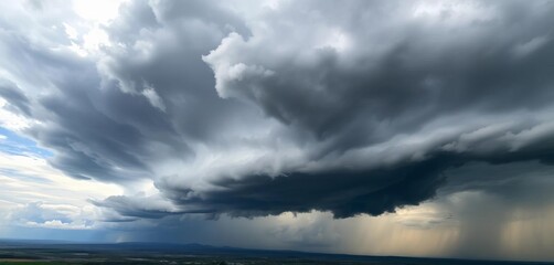 Heavy, dark gray thunderclouds dominate a panoramic horizon, a stormy sky , dark sky, dramatic