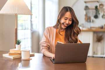 Young smiling asian woman happy relax use laptop conference work,learning, education, shopping, study online, webinar, online marketing, business, blog, digital internet advertising at home