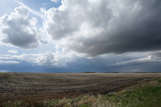 Dark storm clouds rolling over a farmers field in the Canadian Prairies.