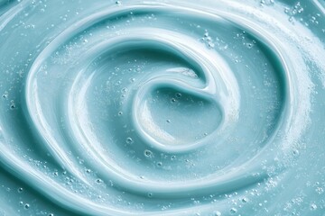 Close-up of smooth glossy light blue liquid swirling with small air bubbles creating a calming and fluid motion