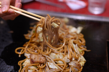 Japanese yakisoba on an iron plate, Japanese cuisine. Japanese fried noodles cuisine.