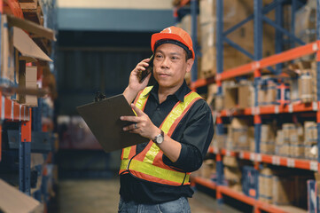 Asian man warehouse managers checking stock in workplace warehouse. industry logistic export import...