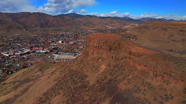 Winter morning front range Coors Beer Factory Lookout North Table Mountain downtown Golden Colorado aerial drone Denver Suburbs neighborhood city sunny blue sky snow on hills forward upwards motion
