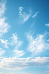 Obraz premium Blue sky with scattered white clouds creating a calm and peaceful atmosphere on a clear day