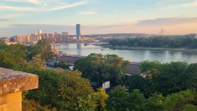 Golden hour view from Kalemegdan Fortress over Belgrade&rsquo;s new waterfront district and the calm Sava River at sunset, capturing the city&rsquo;s contrast of history and modernity