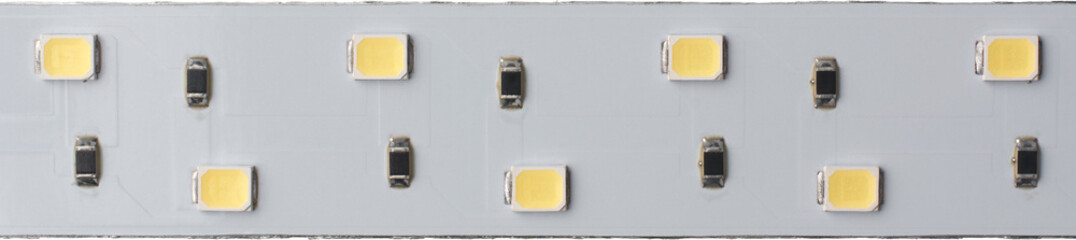 close-up macro view of white LED strip light isolated white background, flexible electronic...