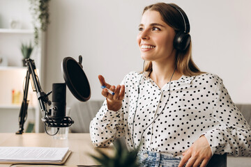 Radio host speaking with microphone and headphones in radio station