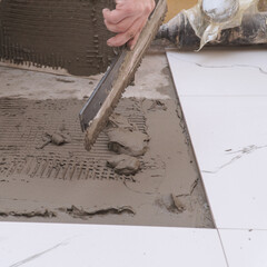 Hand Applying Tile Adhesive for Flooring Installation