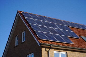 Fototapeta premium Modern House with Solar Panels on Roof for Sustainable Energy in Residential Area
