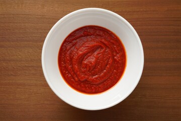 Overhead View of Fresh Tomato Sauce in White Bowl on Wooden Table Surface