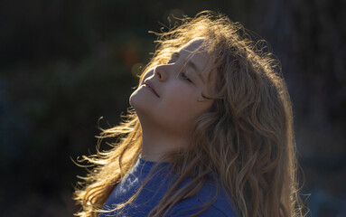 Child in a daydream. Carefree childhood in nature. Dreamy kid. Thoughtful child. Little child...