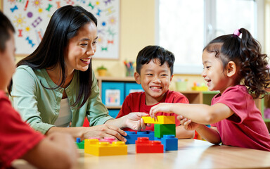 Smiling Asian Teacher and Two Young Children Playing with Colorful Building Blocks in a Preschool Classroom. Creativity and Skill Development Through Play-Based Learning