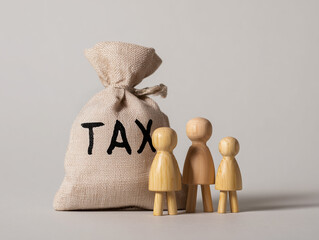  "TAX" bag with three wooden human figures beside it, symbolizing family financial stress. Soft lighting, neutral background, low contrast, stock photo style.