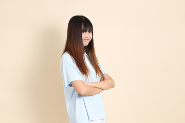 Obraz premium 20s Asian Woman in Light Blue Shirt and White Shorts