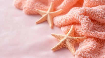 summer concept. Soft towels with starfish on a pink background create a serene beach vibe.