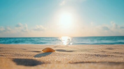 summer concept. Serene beach scene with a shell and glowing sun over the ocean.