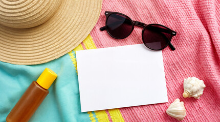 A white card with a blank space on it is on a pink blanket