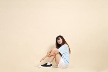20s Asian Woman in Light Blue Shirt and White Shorts